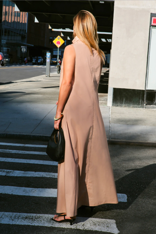 Back view of the Minna Sleeveless Dress worn by Nane walking across a crosswalk in the city.