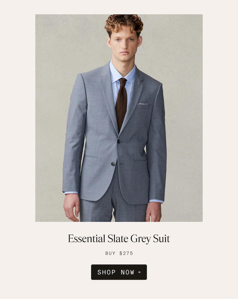 Man wearing the Essential Slate Grey Suit with a light blue dress shirt and brown knit tie. Text reads: Essential Slate Grey Suit. BUY $275. SHOP NOW →