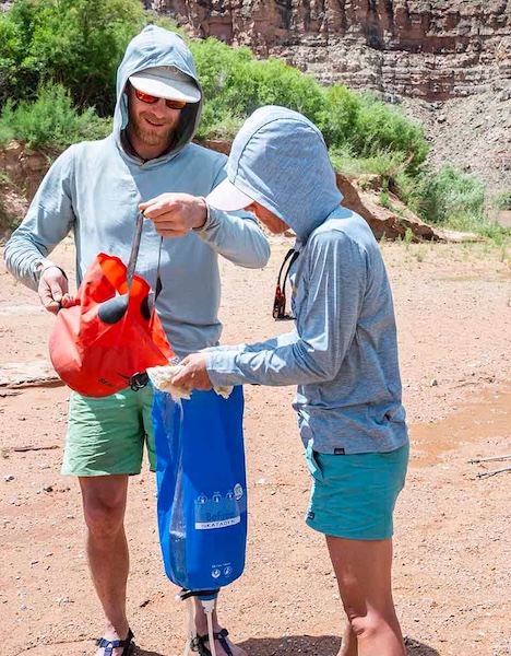 a man and a woman are standing in the dirt