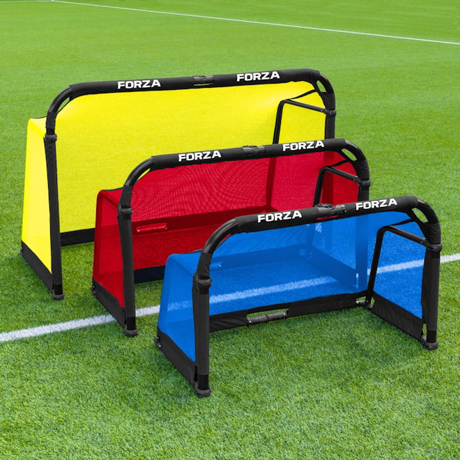 Two juniors playing soccer with the FORZA 12ft x 6ft Goal.
