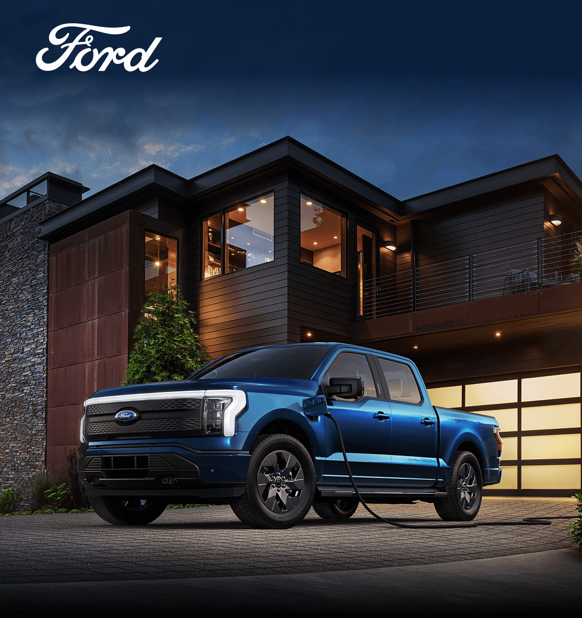 A Blue F-150 Lightning charging in a house’s driveway.