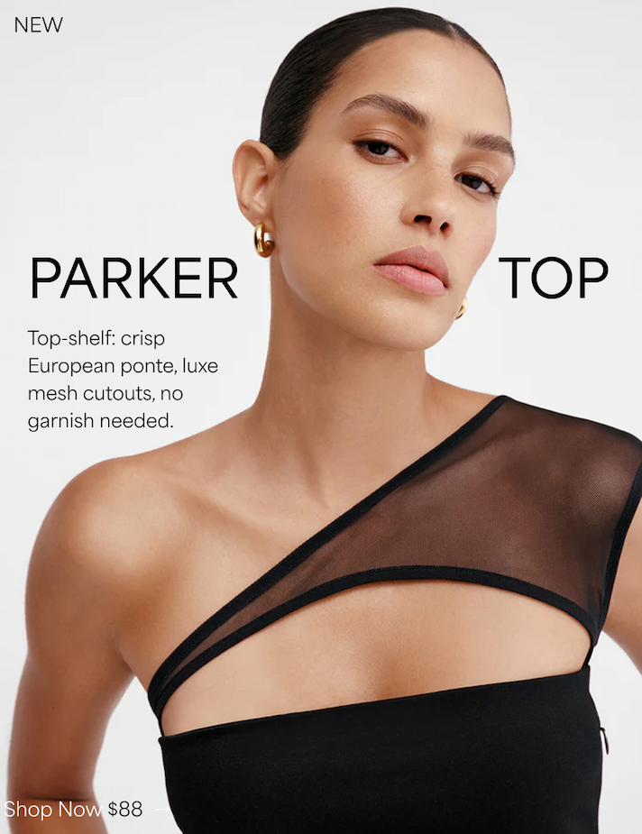 Astrid wears The Parker Top with a sheer mesh cutout across the neckline, styled with gold hoop earrings.