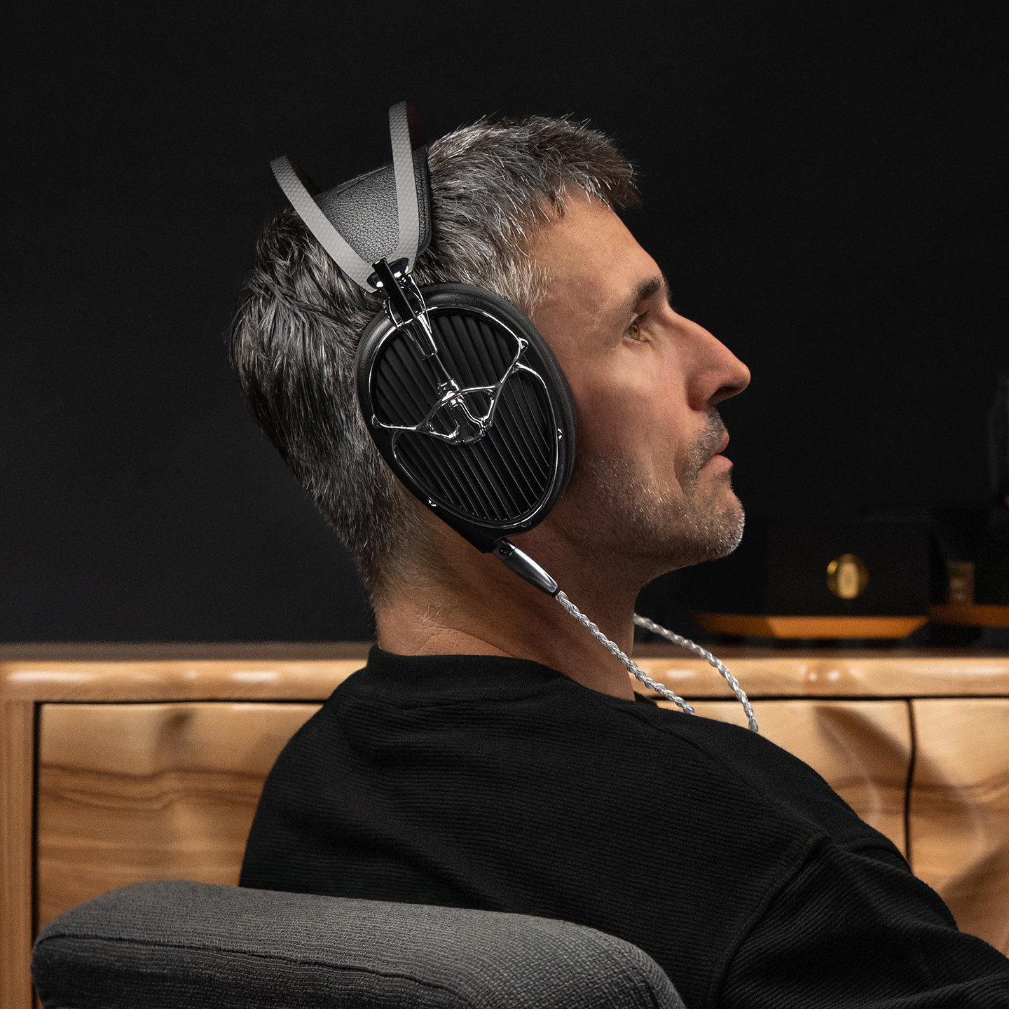 Meze Audio ARTA flagship planar magnetic headphones worn by gray haired man