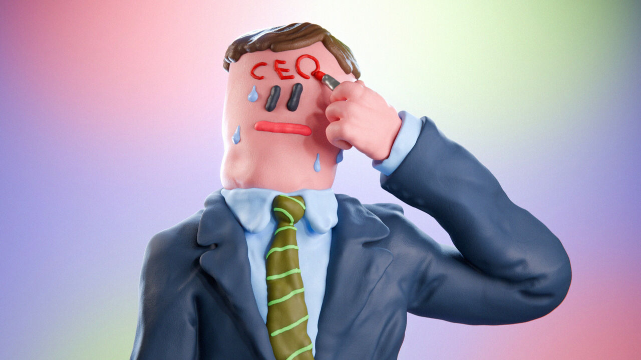 A suited man writing CEO on his forehead