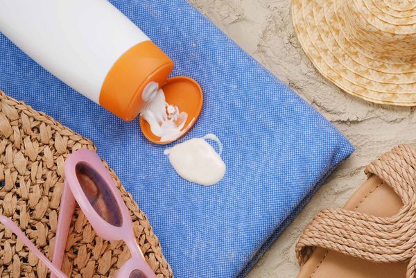 Photo: Generic stock image of a nondescript sunscreen bottle leaking onto a beach towel.