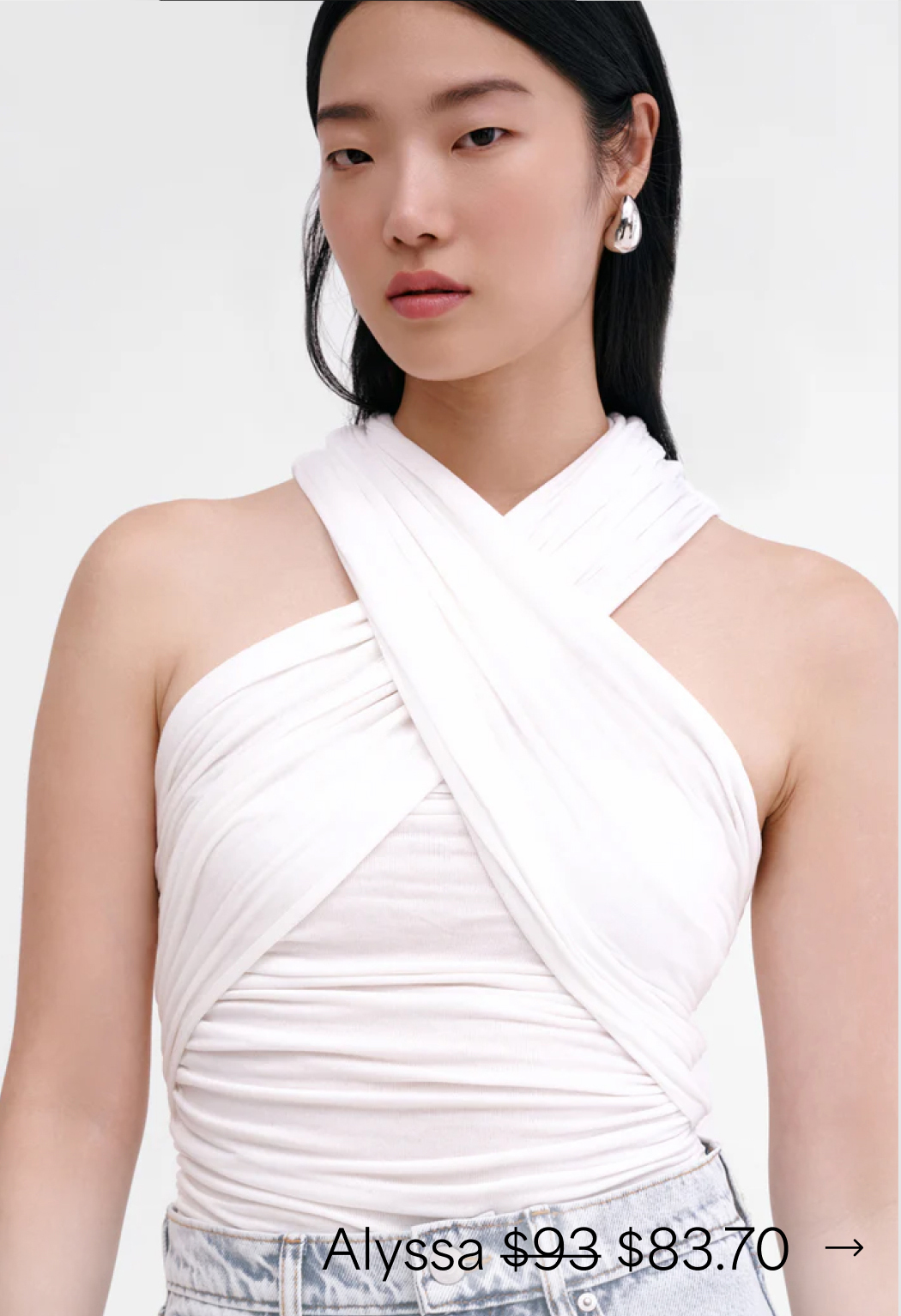 Xun wearing The Alyssa Infinity Top with gentle ruching and light-wash denim.