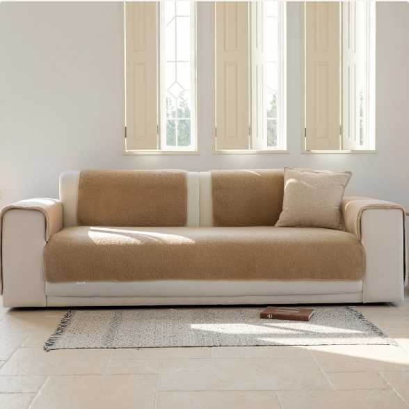 Sofa featuring the Magic Sofa Mat in light brown Sherpa texture.
