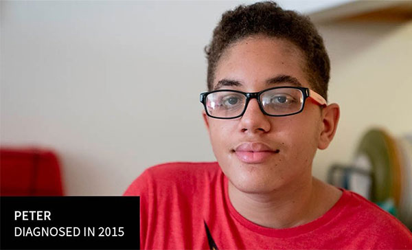 A young man with glasses wears a red T-shirt. A caption reads “Peter, diagnosed in 2015”.