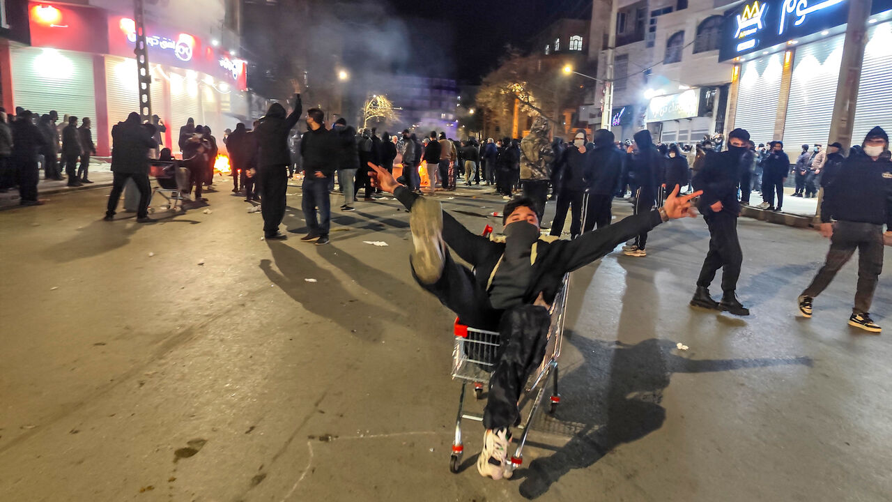 Iranians gather while blocking a street during a protest in Kermanshah, Iran.