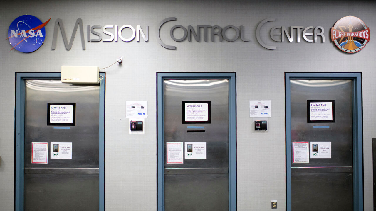 A sign reading Mission Control Center is displayed above doorways at the Johnson Space Center's Mission Control Center in Houston