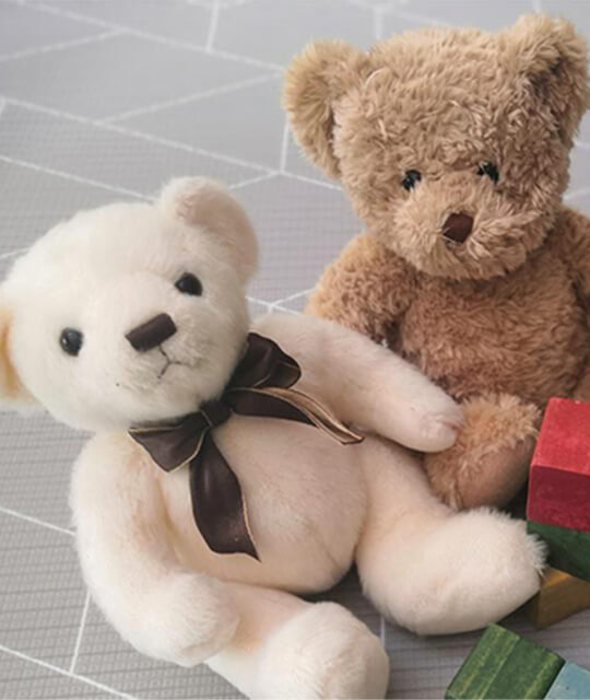 Teddy bears playing with building blocks.