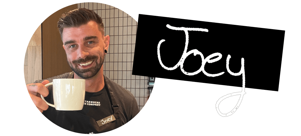 Joey | Circular photograph of a barista in a green apron holding a coffee drink in a white mug. A black name tag next to them reads "Joey" in white handwriting.