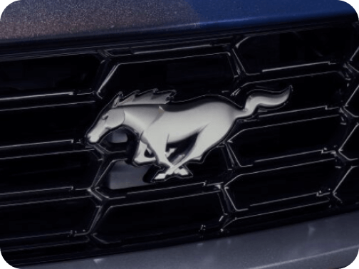 Close‑up of silver Mustang&reg; logo on front grille