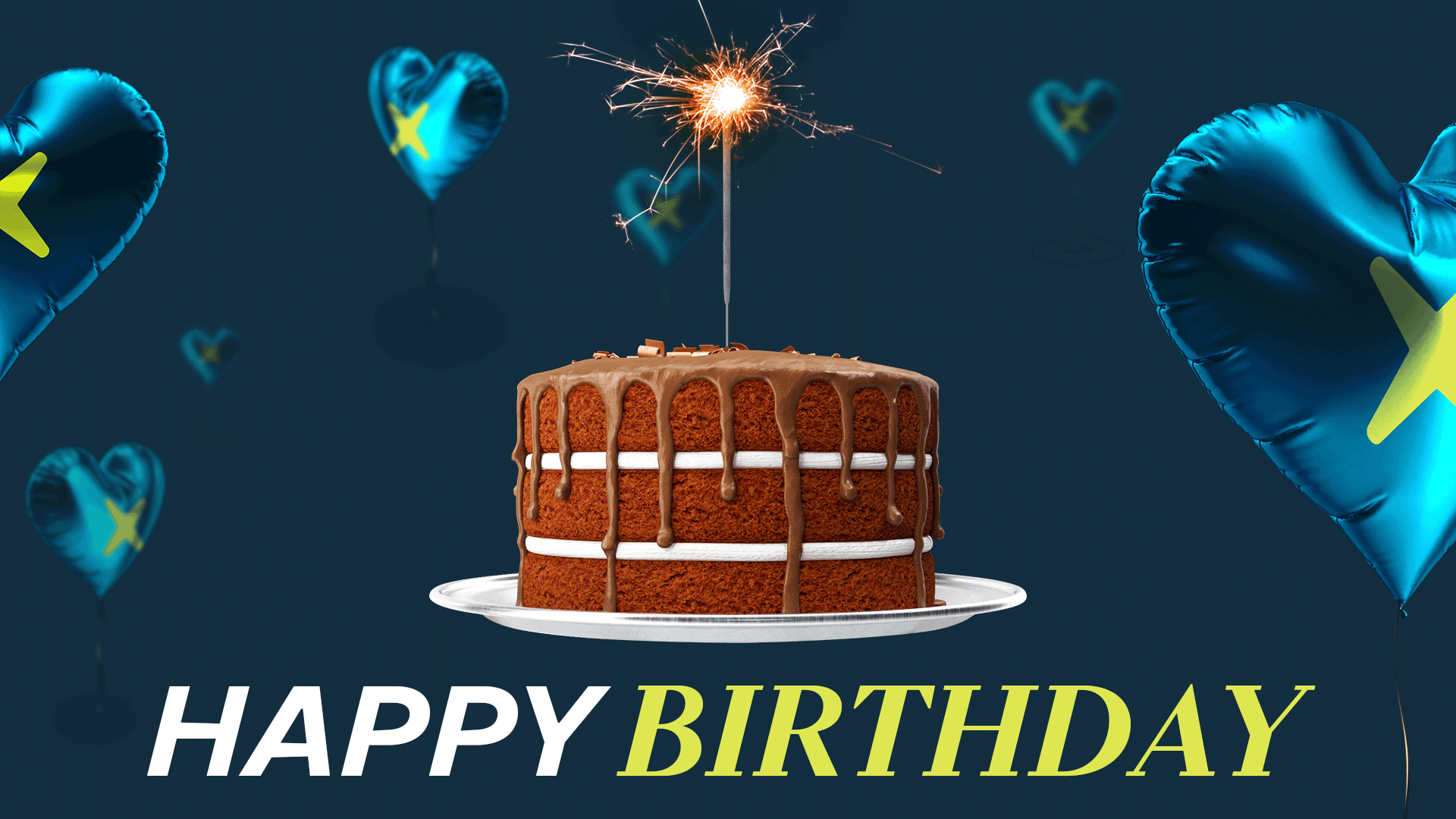 Shiny blue heart-shaped balloons with a green X are dotted around a chocolate. Icing drips down the layers as a sparkler flickers in time with the happy birthday written below the cake.