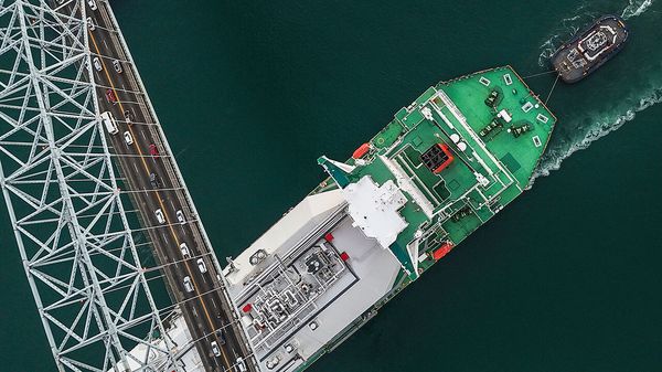 A liquefied natural gas carrier sails under Las Americas Bridge through the Panama Canal 