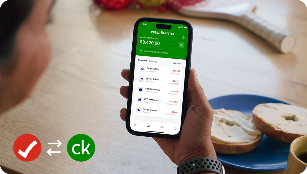 iPhone screen displaying the Credit Karma app account balance and Intuit TurboTax + Intuit creditkarma logos