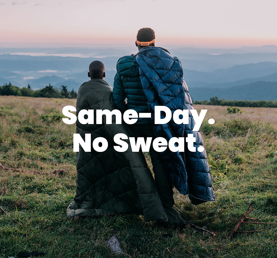 Son & father wear Rumpl blankets as they gaze at distant hilltops