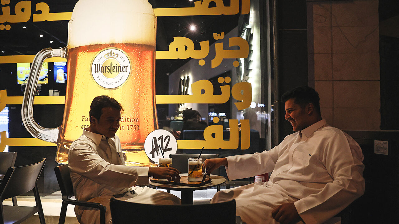Saudi customers drink non-alcoholic draft beer at the A12 cafe in the capital, Riyadh