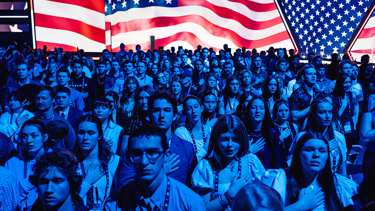 Attendees observe the National Anthem during AmericaFest.