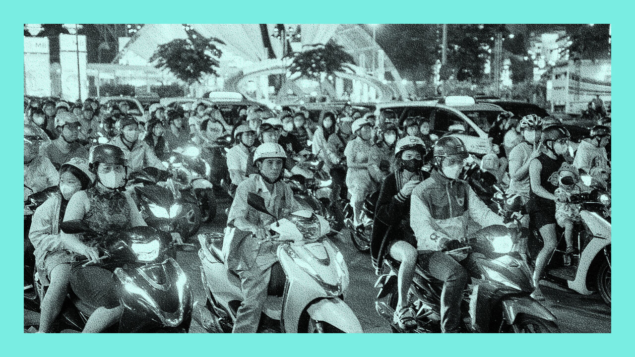 Numerous motorcycles fill the roadway in Ho Chi Minh City, Vietnam.