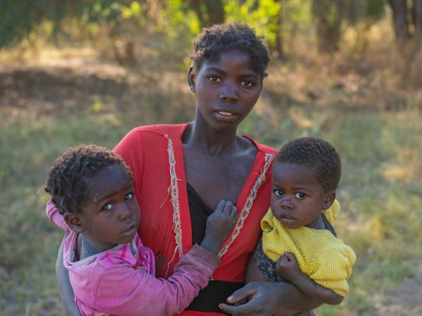 Mundube, a mother in Zambia, holding her two children