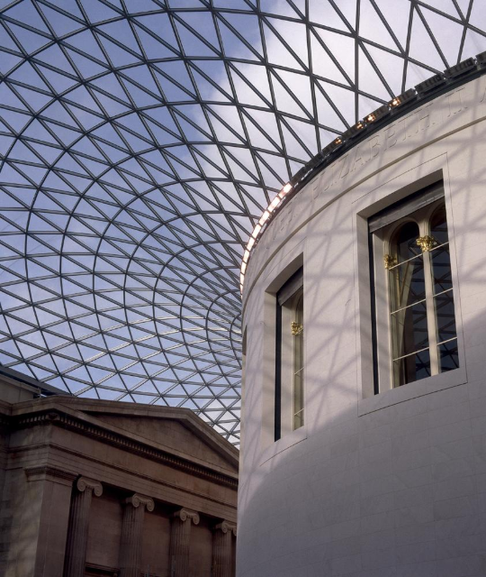 Drawing of two people walking in front of a the front facade of the British Museum. 