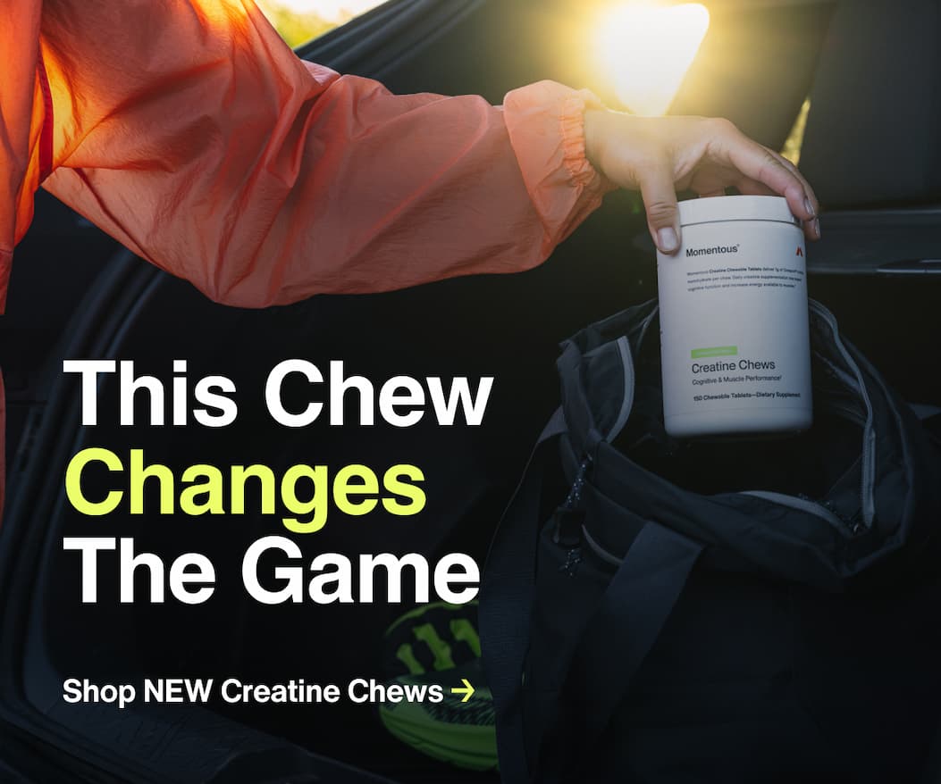 Person wearing an orange jacket placing a container of Momentous Creatine Chews into a gym bag with text overlay reading 'This Chew Changes The Game' and 'Learn More About The Innovation Behind Creatine Chews'.