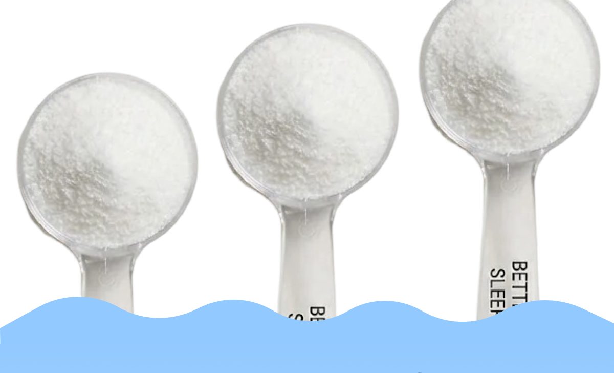 Three clear measuring spoons filled with white powder against a blue background.