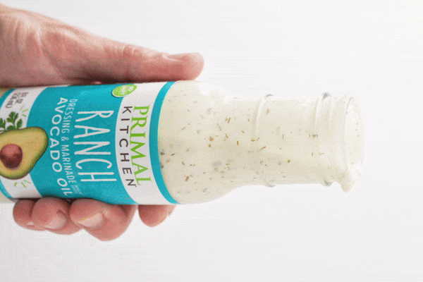 Primal Kitchen Ranch Dressing pouring out of the bottle