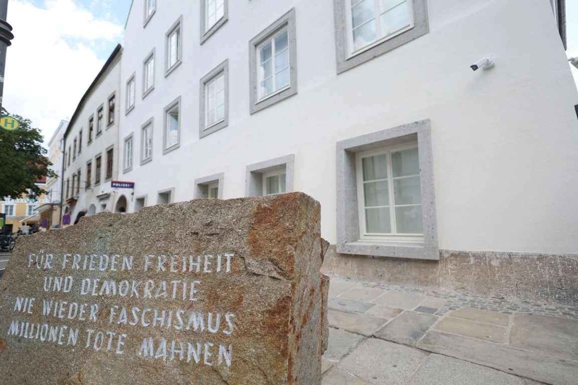 A stone memorializing the millions of deaths during the Holocaust outside the newly converted police station. 