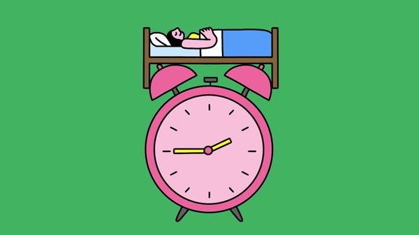 A person sleeping in bed on top of a large alarm clock