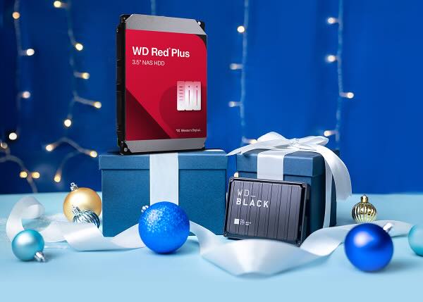 Two Western Digital hard drives, WD Red Plus and WD Black, presented as holiday gifts with blue boxes, white ribbons, and Christmas ornaments against a blue bokeh background.