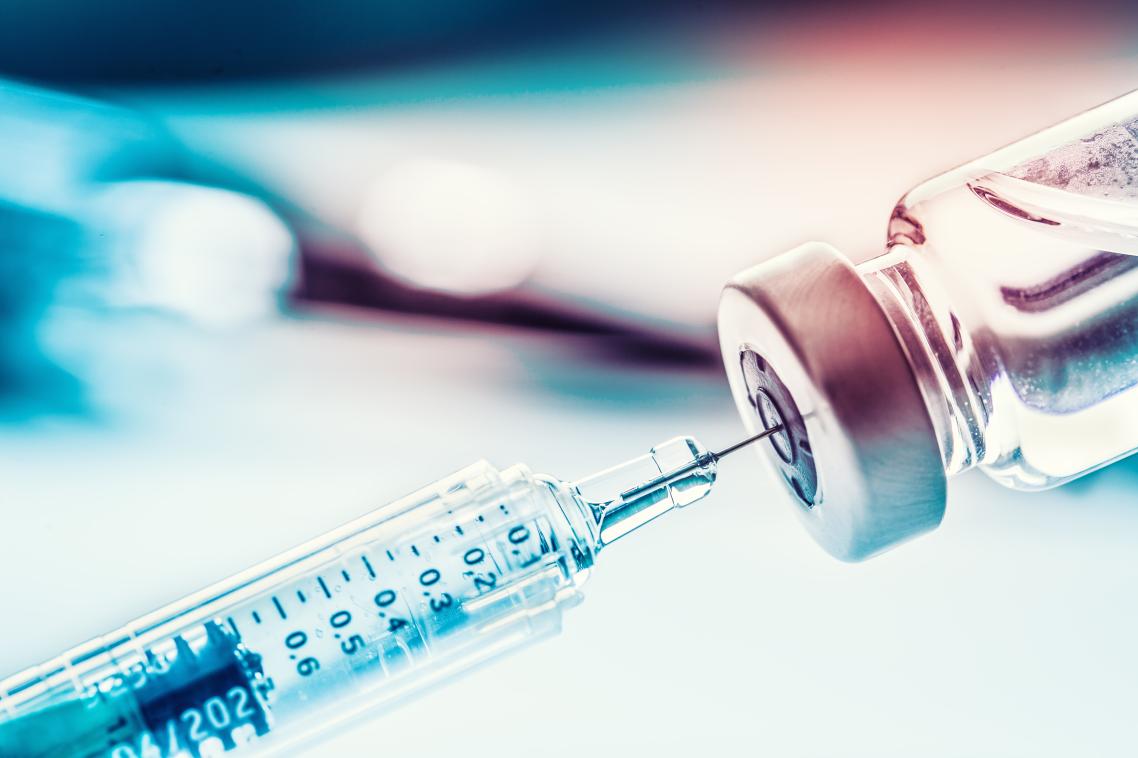 A needle with a blurred blue background.