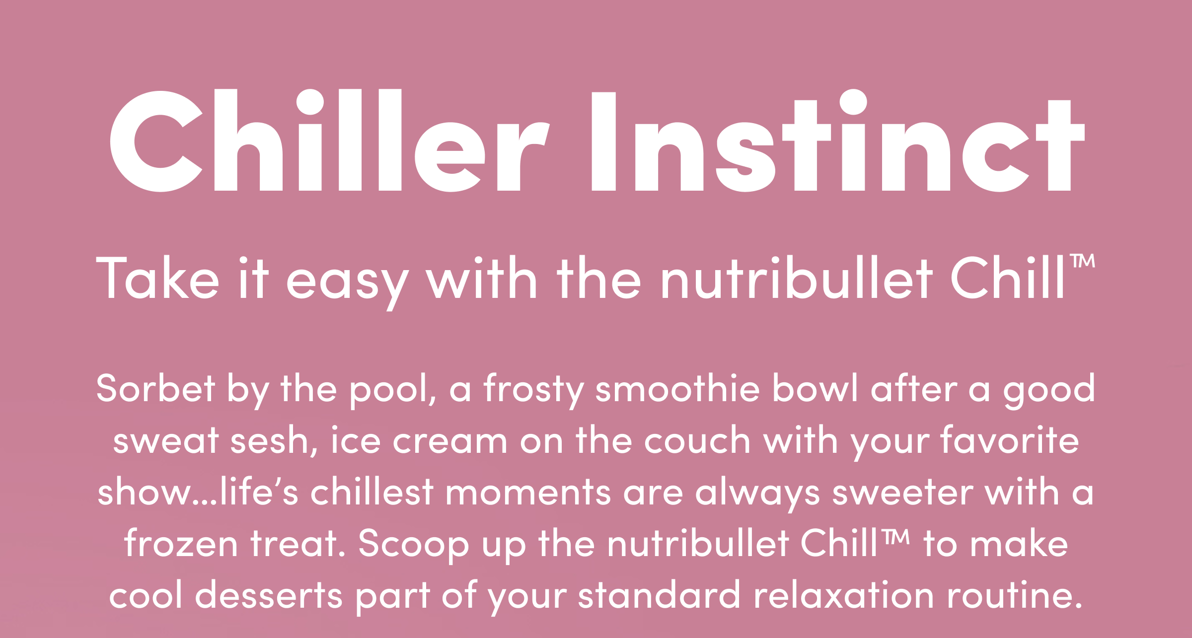 A white nutribullet Chill™ Ice Cream Maker beside a pink ceramic bowl and a waffle cone stacked with strawberry scoops.