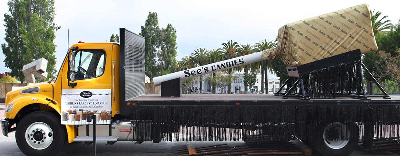Oversized See&rsquo;s Lollypop on a flatbed semi truck