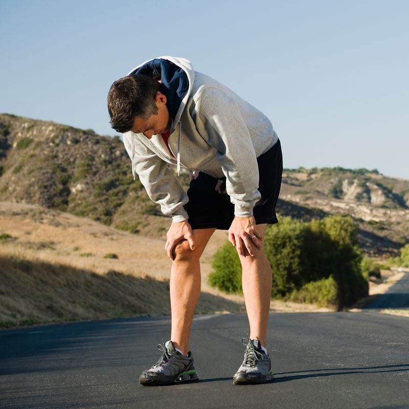 A person resting while out for a jog.