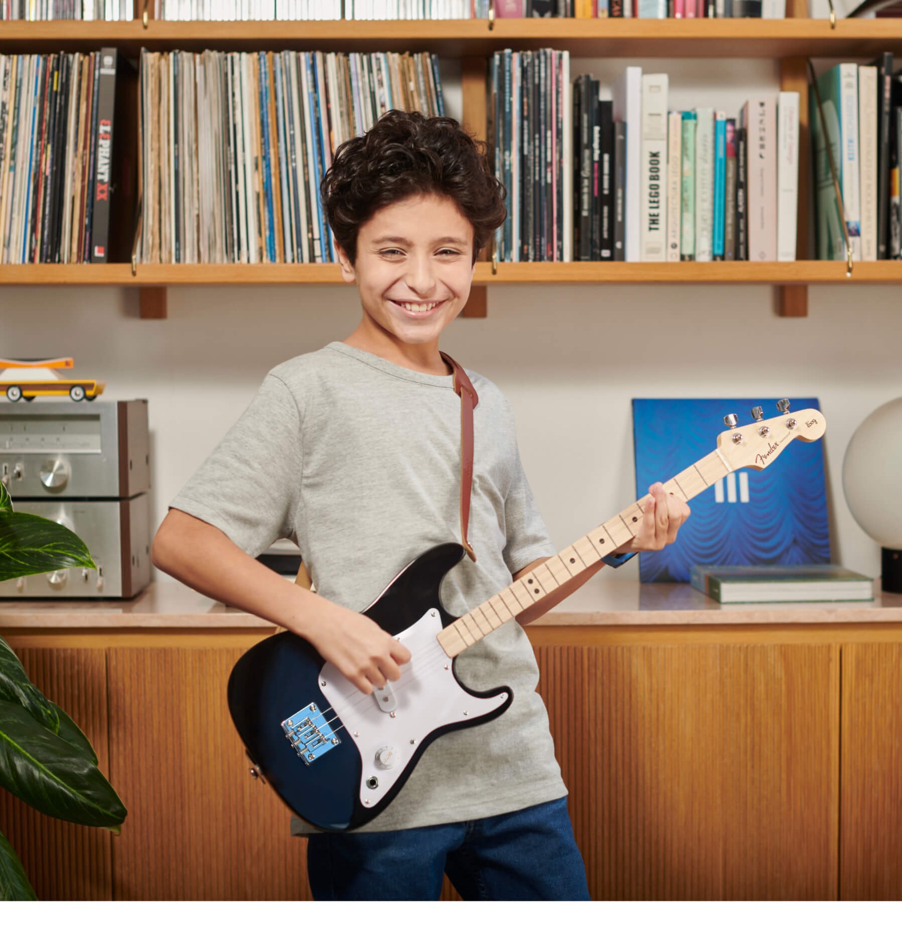 kid playing Fender x loog guitar