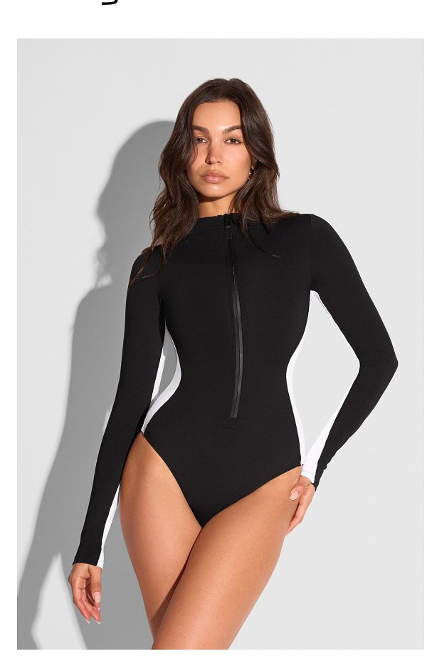 Black and white long-sleeve swimsuit with a front zipper.