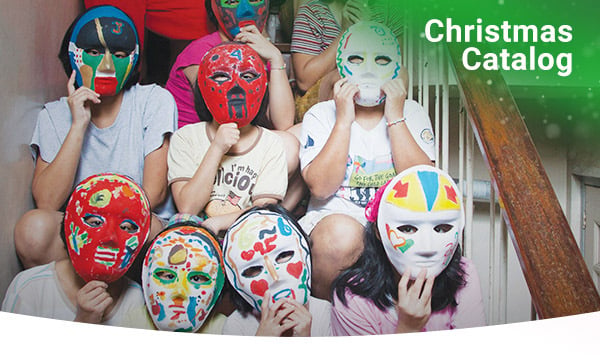 Girls hold the colorful masks they created over their faces. 