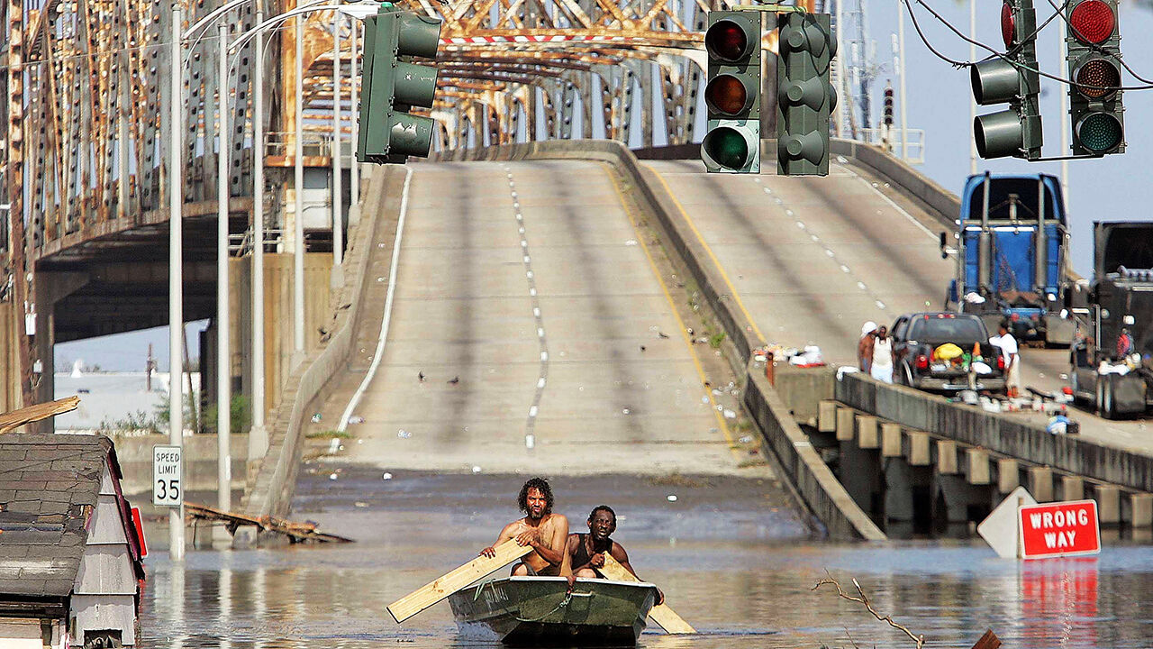 Two men paddle in high water after Hurricane Katrina devastated the area, August 31, 2005 in New Orleans, Louisiana.