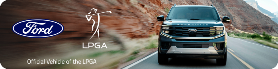 A front shot of an Expedition&reg; SUV driving on a mountain road. To the left we see the Ford logo next to the LPGA logo with text below that reads "Official Vehicle of the LPGA".
