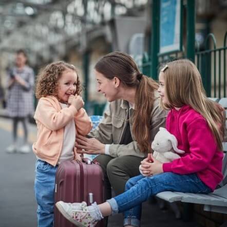 Mother and two children at train station