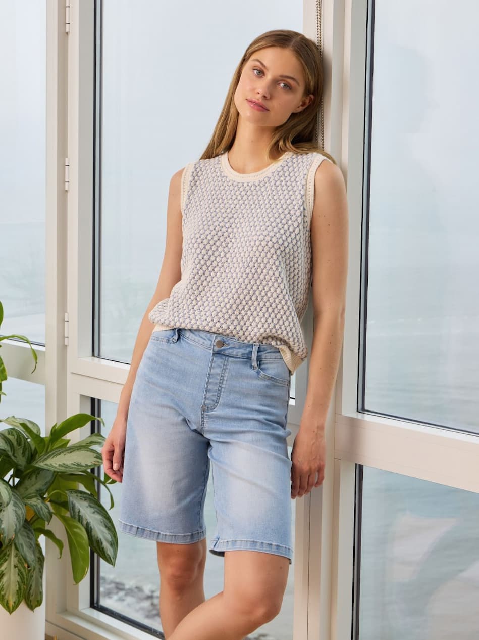Model wearing the Lennon Everyday Bermuda Short Denim styled with the Clair Textured Mesh Sweater for a polished spring-ready look.