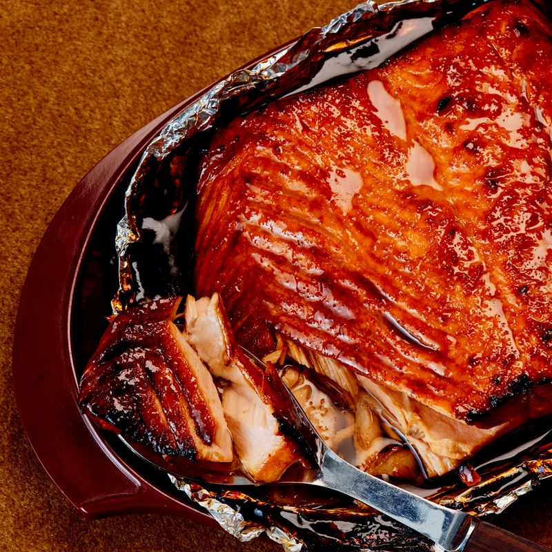 A macro view of a spooned-in, roasted salmon. 