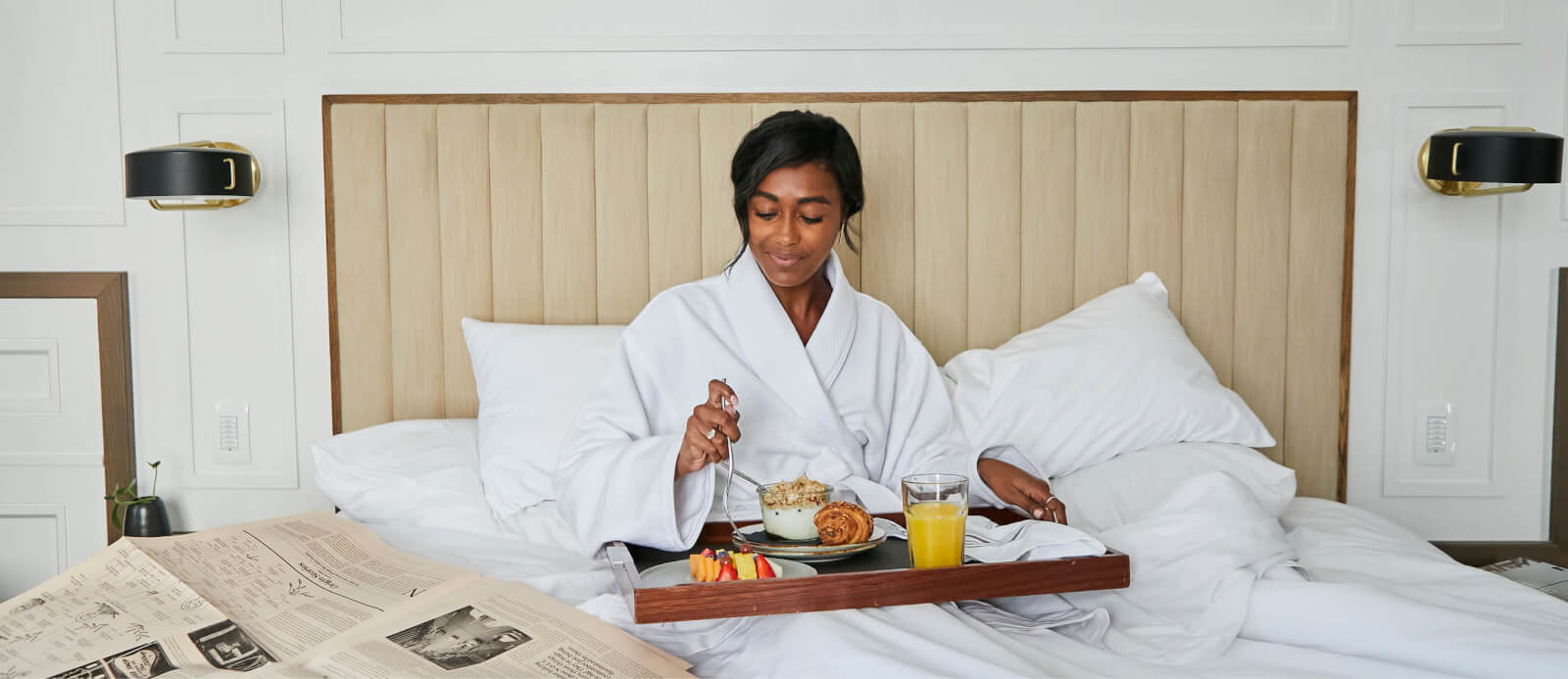 A woman having breakfast in bed.