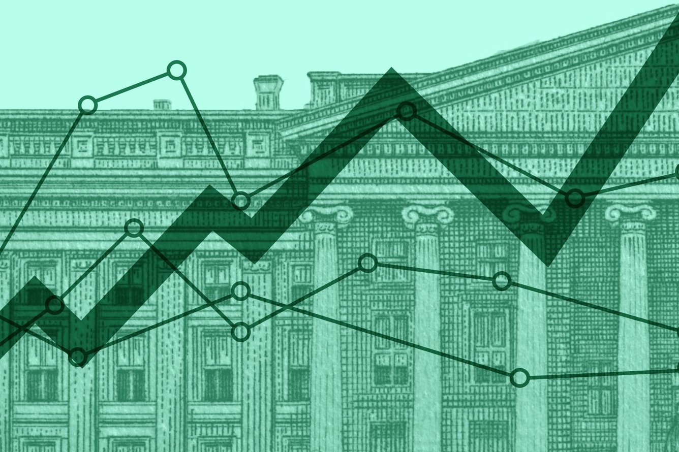 Collage showing a close-up of the Treasury building from the back of US currency, with multiple line graphs superimposed on it, all in shades of green.
