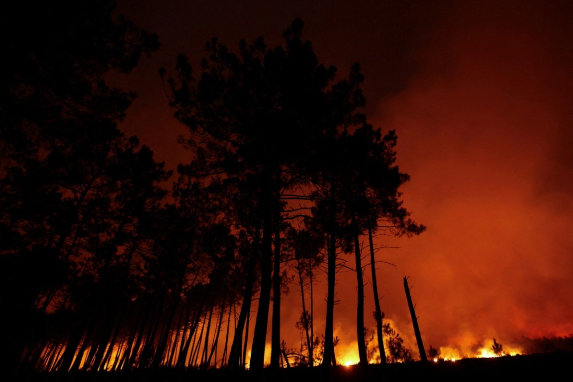Smoke rises as flames burn during a wildfire at Ares, Gironde