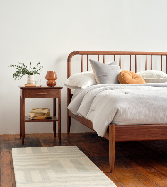 The Bates bed and side table in walnut.