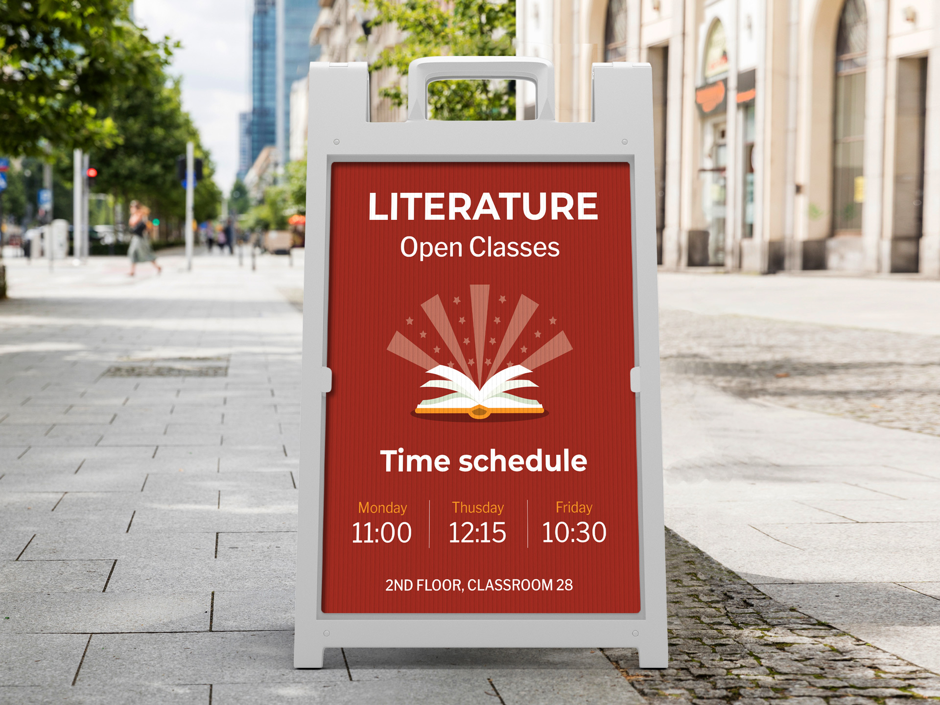 White A-frame sidewalk sign promoting literature open classes with schedule and classroom details on a city sidewalk.