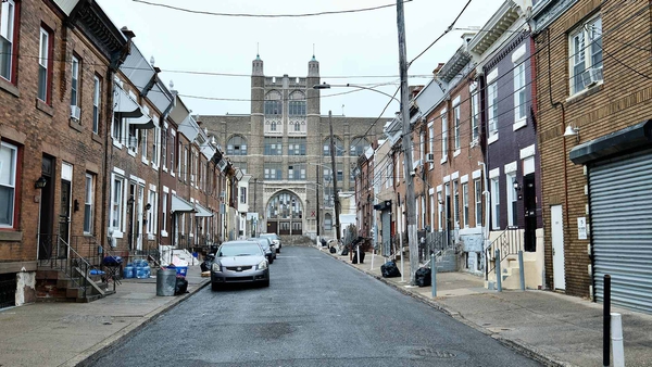 school at end of street lined by townhomes